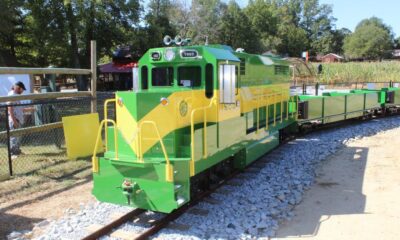 a green train parked at a park